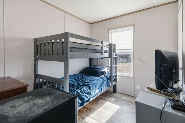 a bedroom with furniture and a window