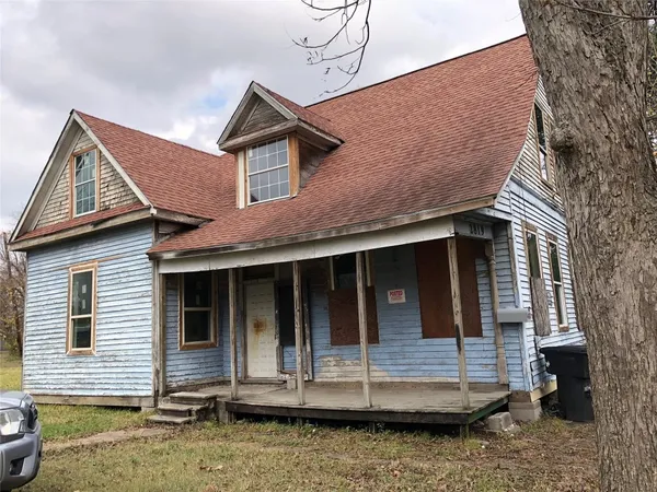 a view of a street with a car parked in the background