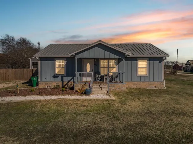 a front view of a house with yard and seating space