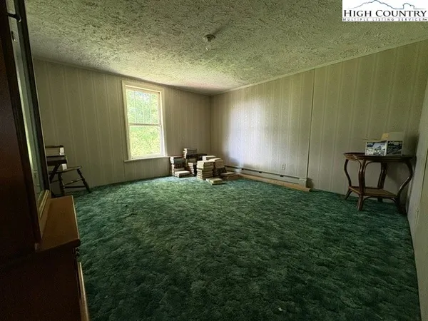 a bedroom with a bed window and walk in closet