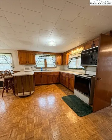 a kitchen with stainless steel appliances kitchen island granite countertop a stove a sink and a microwave