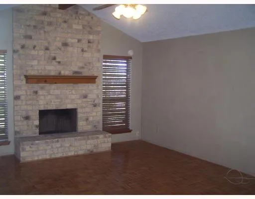 a view of empty room with a fireplace