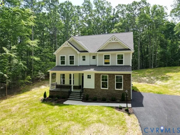 a front view of a house with yard and green space