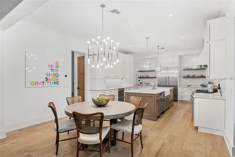 a large kitchen with a table and chairs
