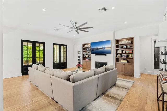 a living room with furniture a fireplace and a flat screen tv
