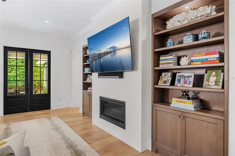 a room with multiple furniture and a book shelf