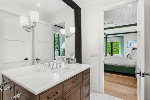a spacious bathroom with a tub sink and mirror