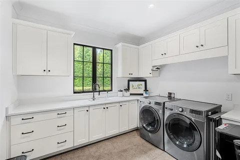 a view of a livingroom with furniture a flat screen tv and a wooden floor