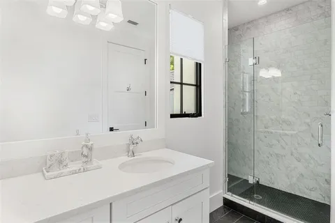 a bedroom with bed and a chandelier