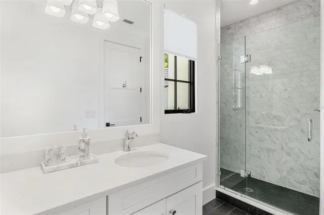 a bedroom with bed and a chandelier