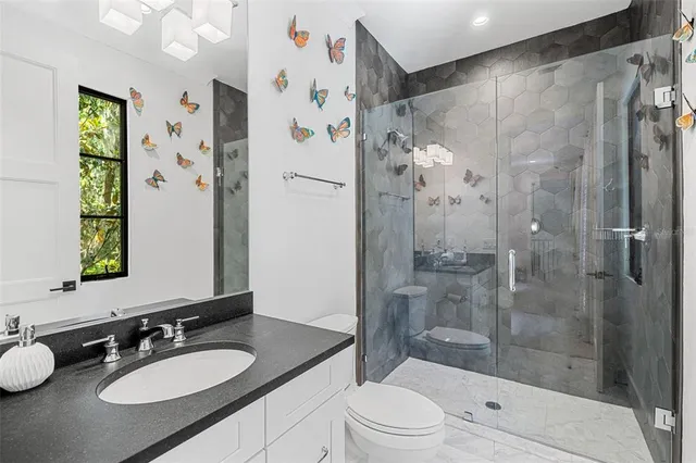 a bedroom with a bed a table and a book shelf