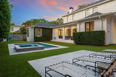 a view of a patio with table and chairs under an umbrella