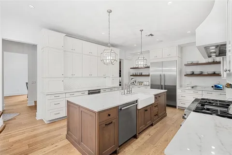 a kitchen with a stove a sink and a refrigerator