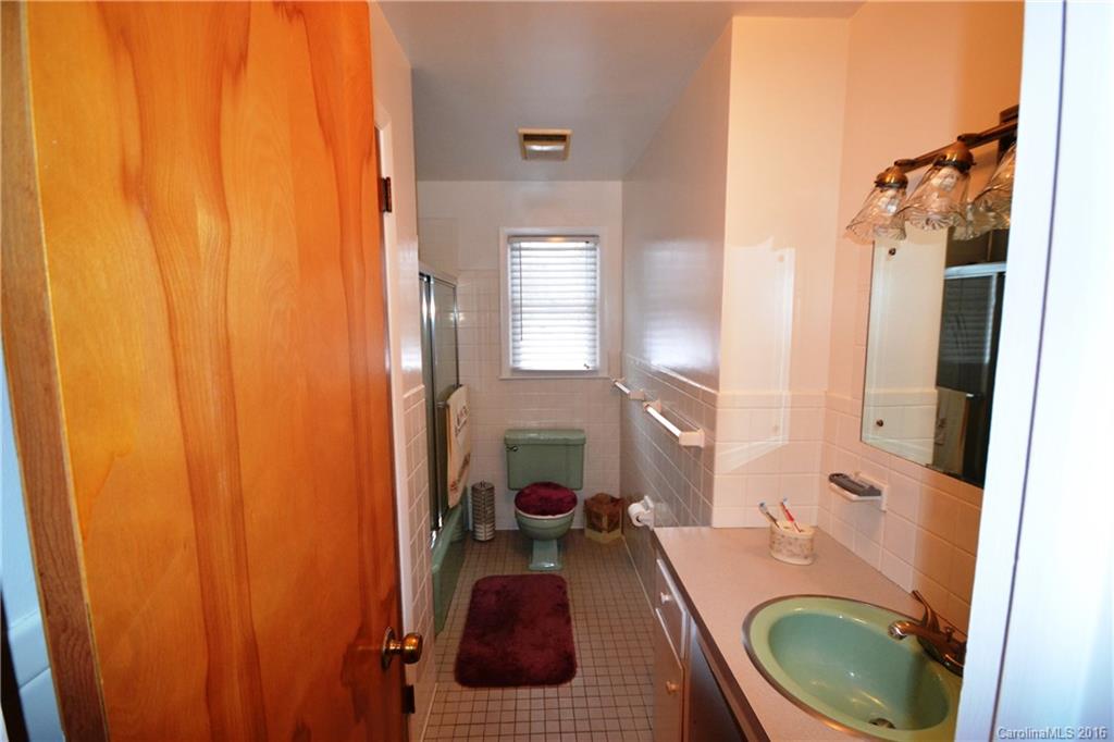445 Loop Road Hendersonville, NC 28792 - Photo 10 of 13 a bathroom with a sink and a mirror