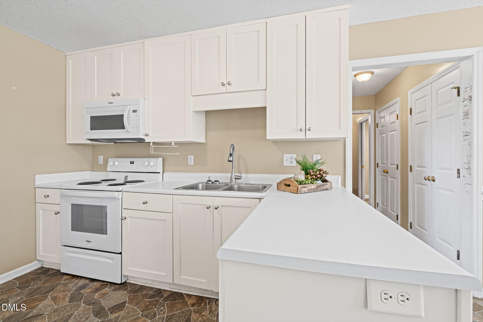 307 Laurel Ridge Drive Clayton, NC 27520 - Photo 11 of 51 a kitchen with granite countertop white cabinets and white appliances