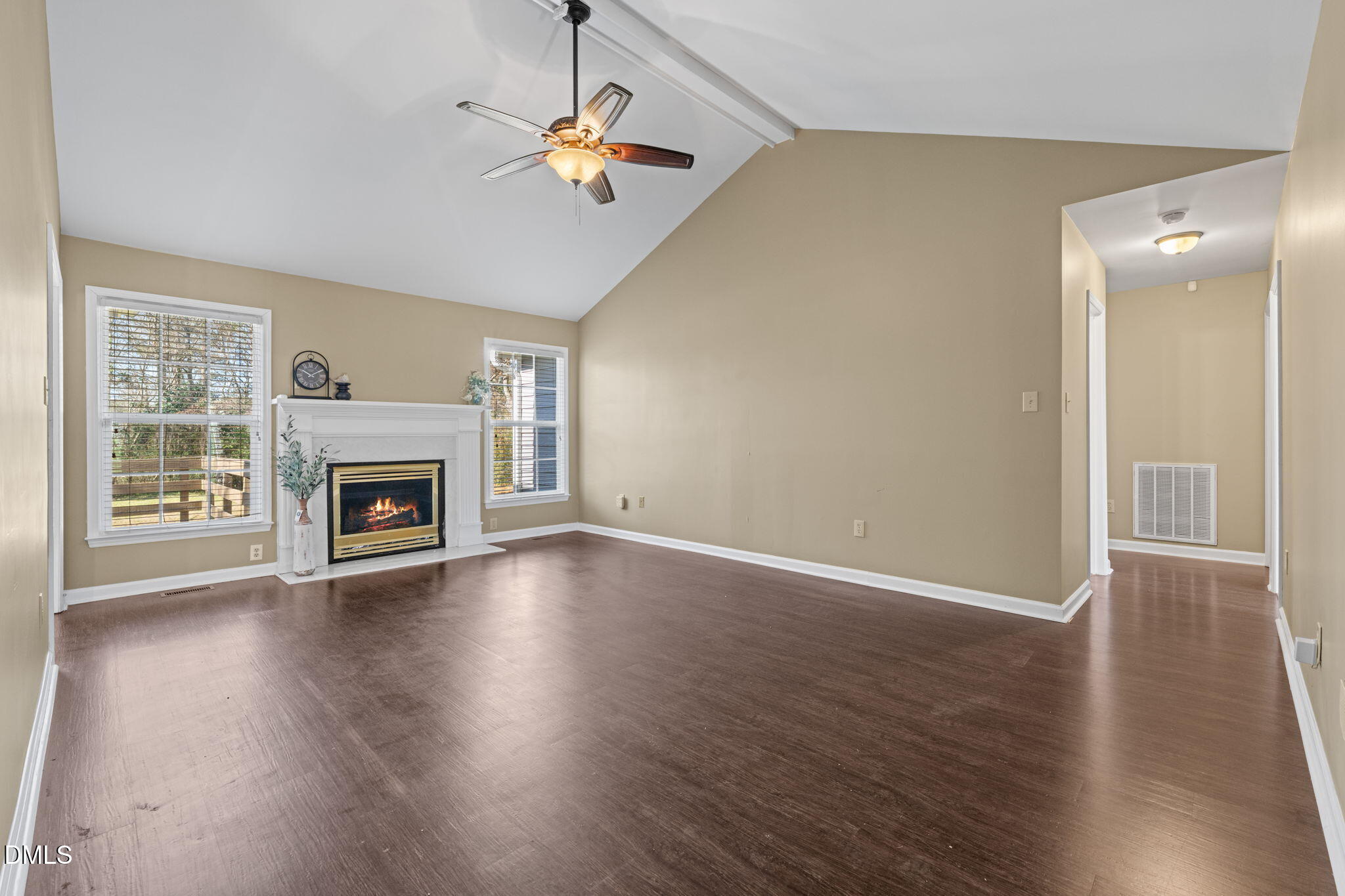 307 Laurel Ridge Drive Clayton, NC 27520 - Photo 13 of 51 an empty room with wooden floor fireplace and windows