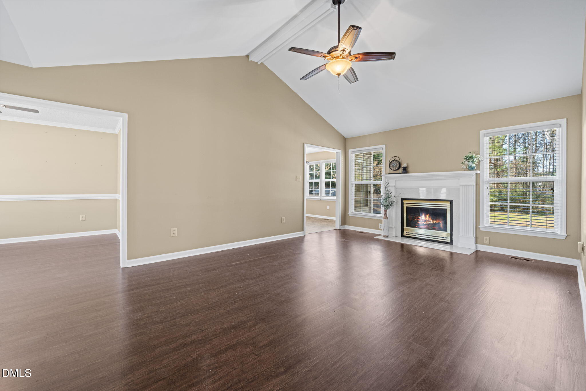 307 Laurel Ridge Drive Clayton, NC 27520 - Photo 14 of 51 an empty room with wooden floor chandelier fan and windows