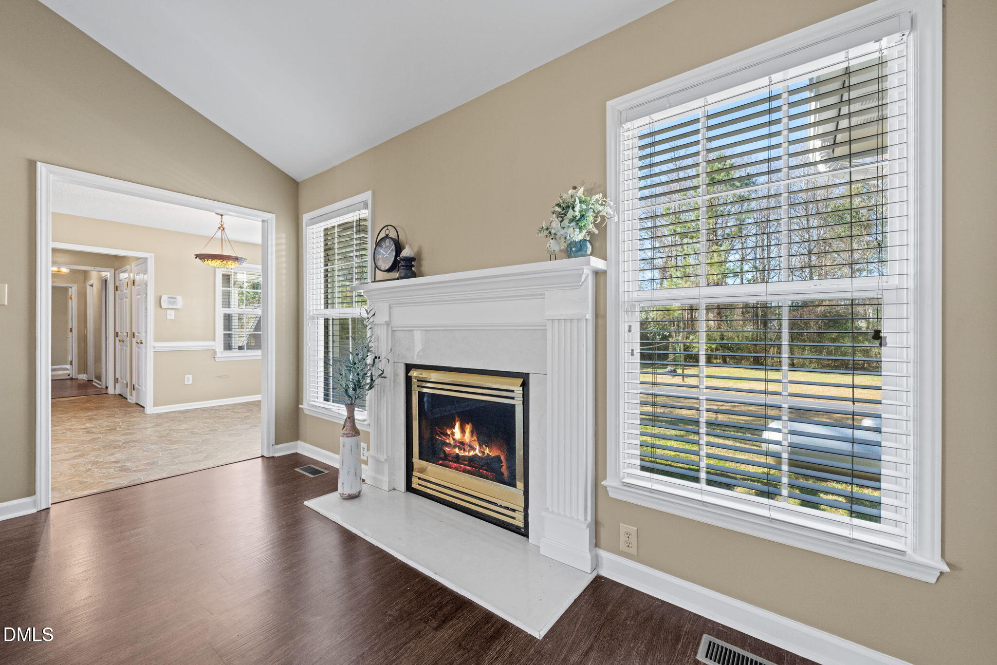 307 Laurel Ridge Drive Clayton, NC 27520 - Photo 16 of 51 a living room with wooden floor and a fireplace