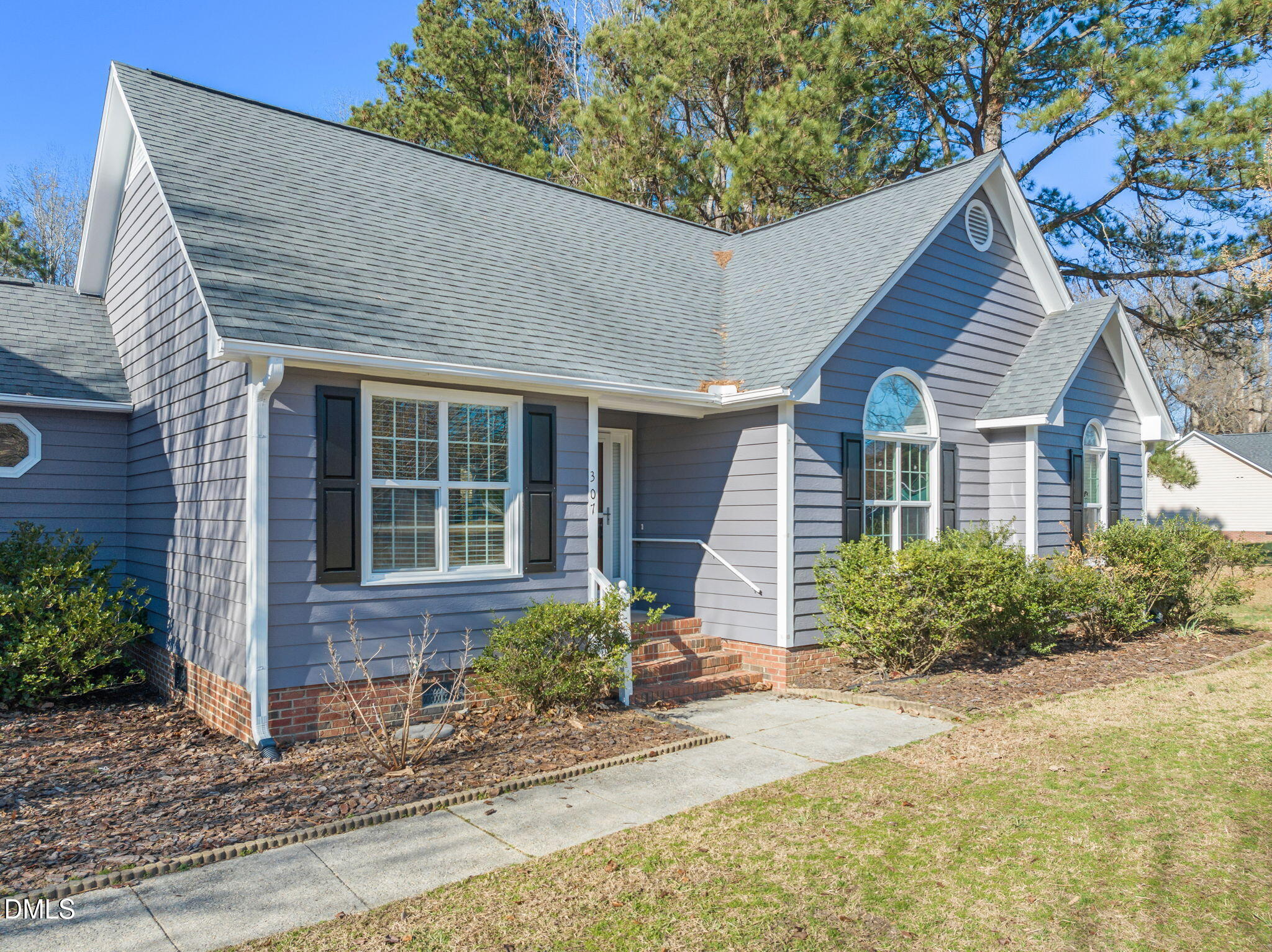 307 Laurel Ridge Drive Clayton, NC 27520 - Photo 2 of 51 a front view of a house with garden