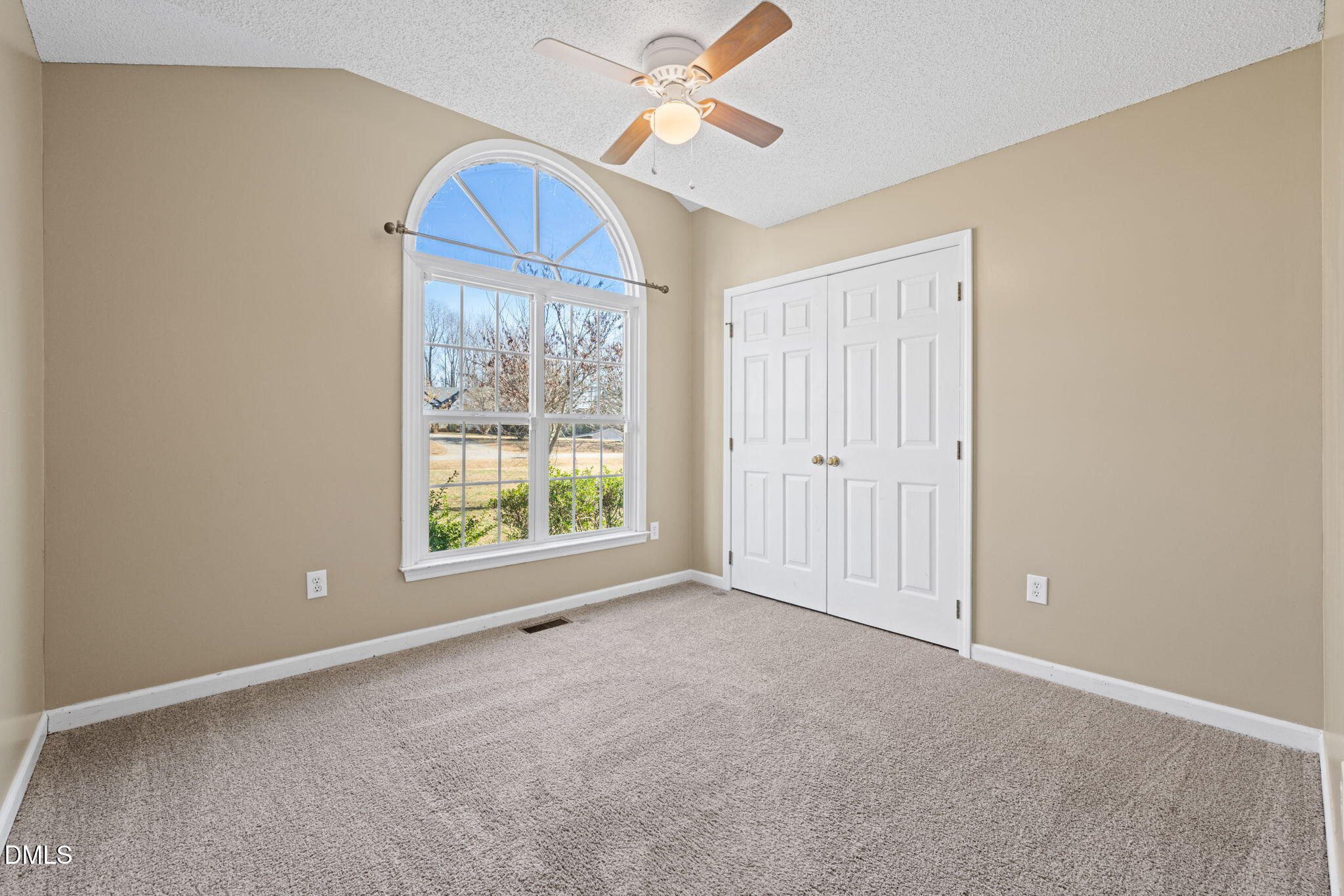 307 Laurel Ridge Drive Clayton, NC 27520 - Photo 27 of 51 an empty room with chandelier fan and windows
