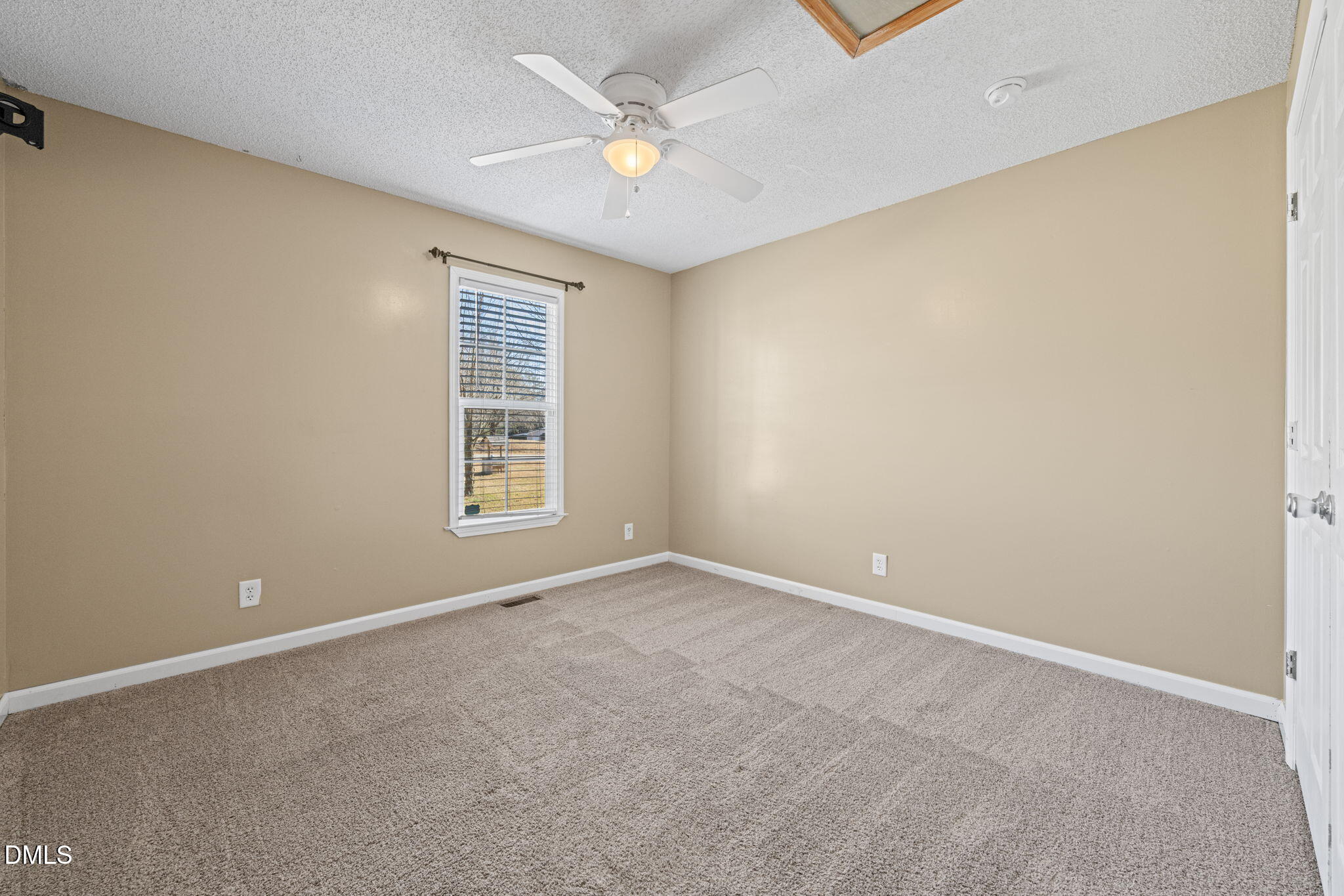 307 Laurel Ridge Drive Clayton, NC 27520 - Photo 31 of 51 an empty room with windows and ceiling fan