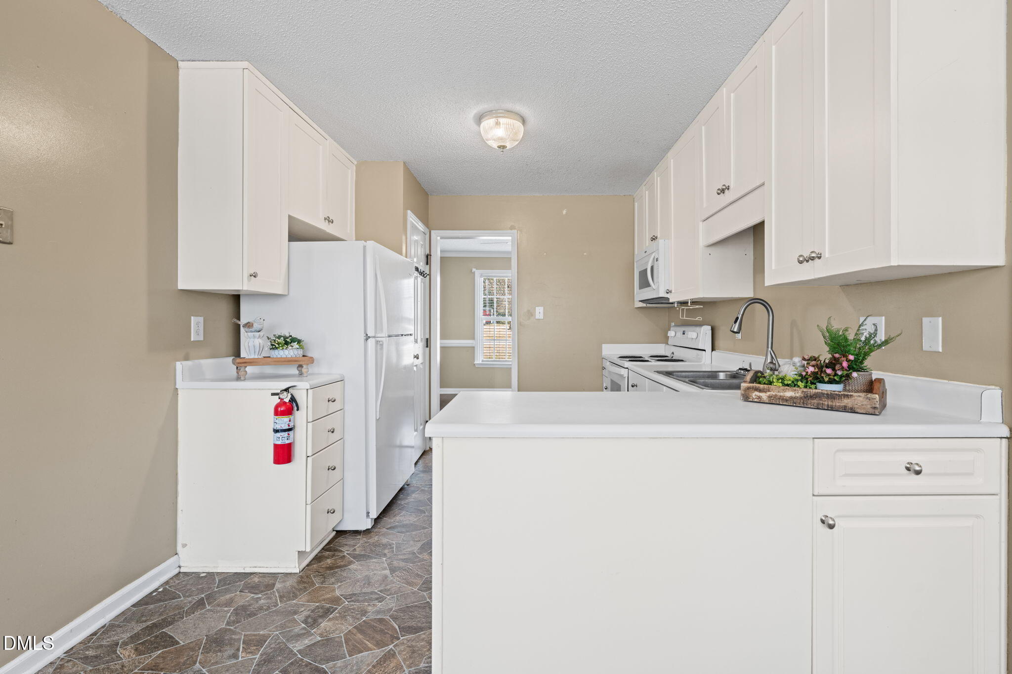 307 Laurel Ridge Drive Clayton, NC 27520 - Photo 10 of 51 a white kitchen with refrigerator and window