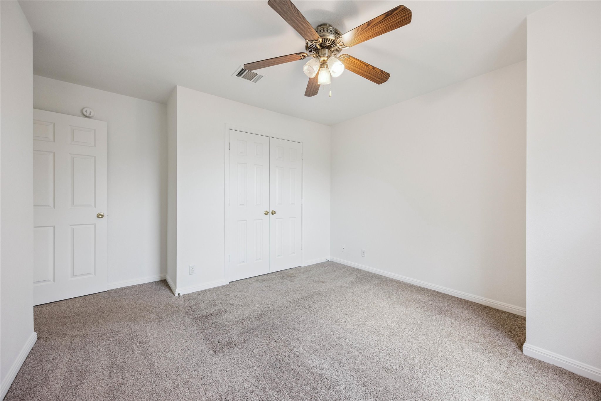 111 North Field Street Round Rock, TX 78681 - Photo 36 of 40 an empty room with a chandelier fan and windows