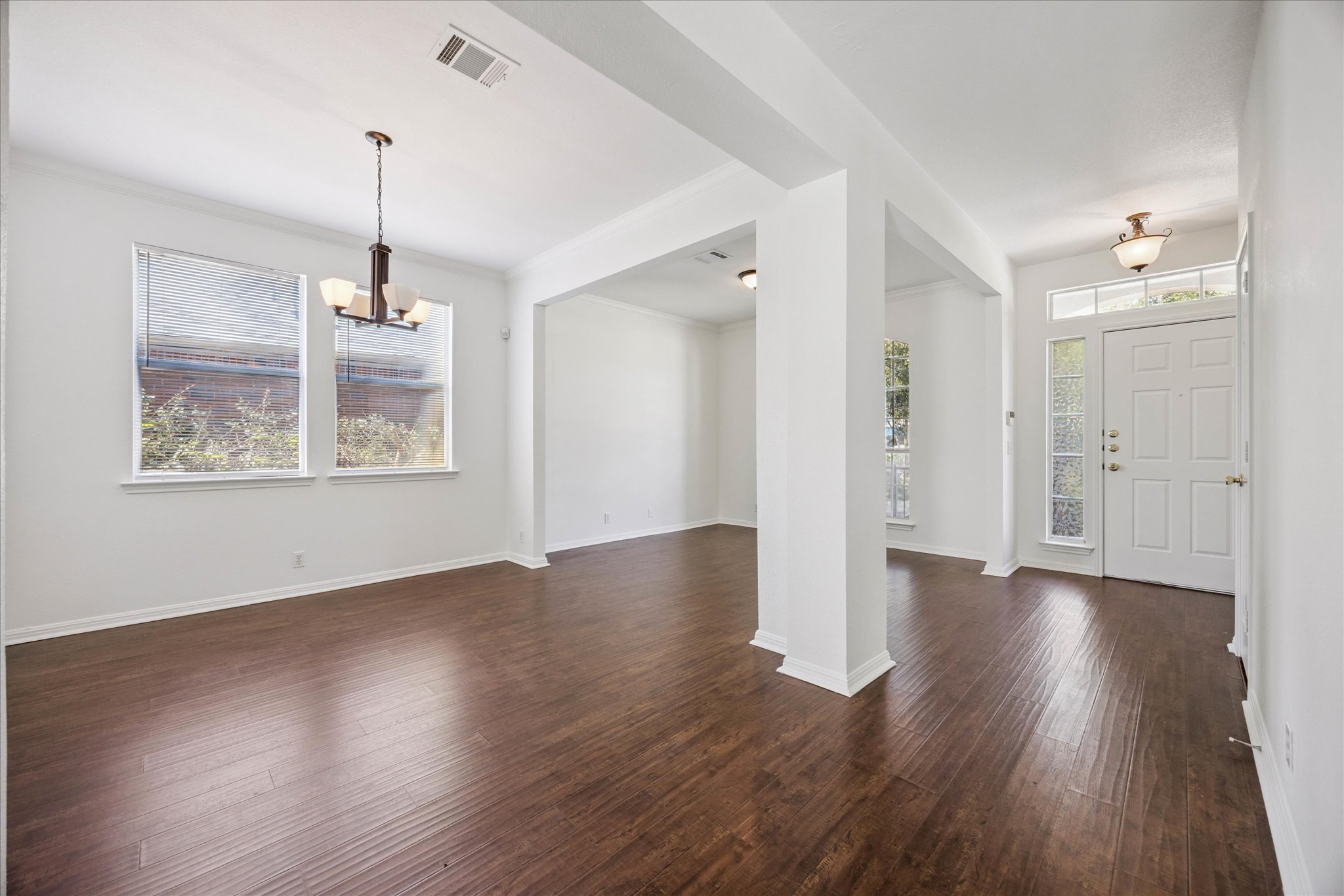 111 North Field Street Round Rock, TX 78681 - Photo 6 of 40 a view of an empty room with wooden floor and a window