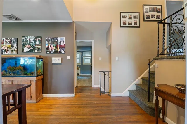 a view of entryway and hall with wooden floor