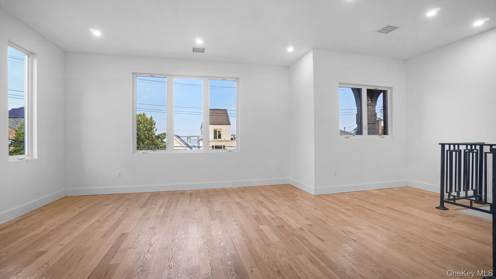 3239 Tierney Place Bronx, NY 10465 - Photo 14 of 31 Empty room featuring light wood-style floors and recessed lighting