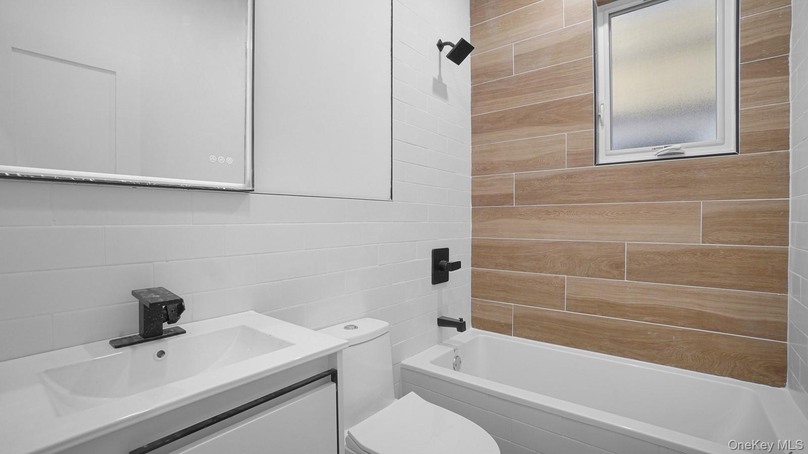 3239 Tierney Place Bronx, NY 10465 - Photo 21 of 31 Full bath featuring tile walls, vanity, and shower / tub combination
