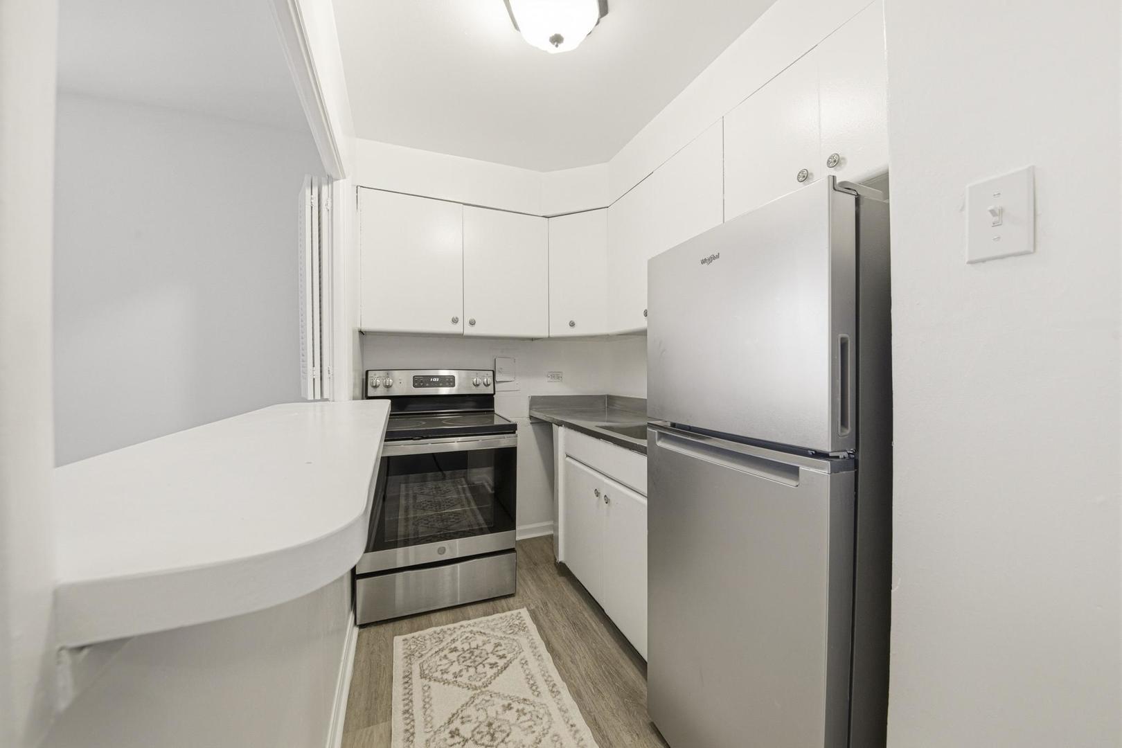 6118 North Sheridan Road, Unit 506 Chicago, IL 60660 - Photo 8 of 13 a kitchen with a refrigerator and a stove