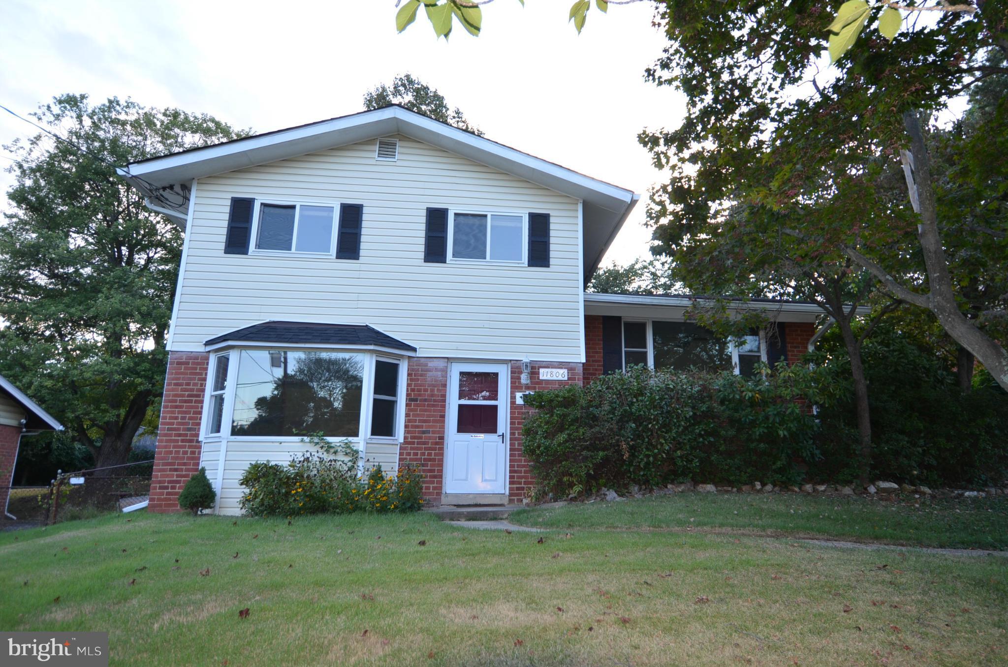11806 Selfridge Road Silver Spring, MD 20906 - Photo 1 of 25 a front view of a house with a garden