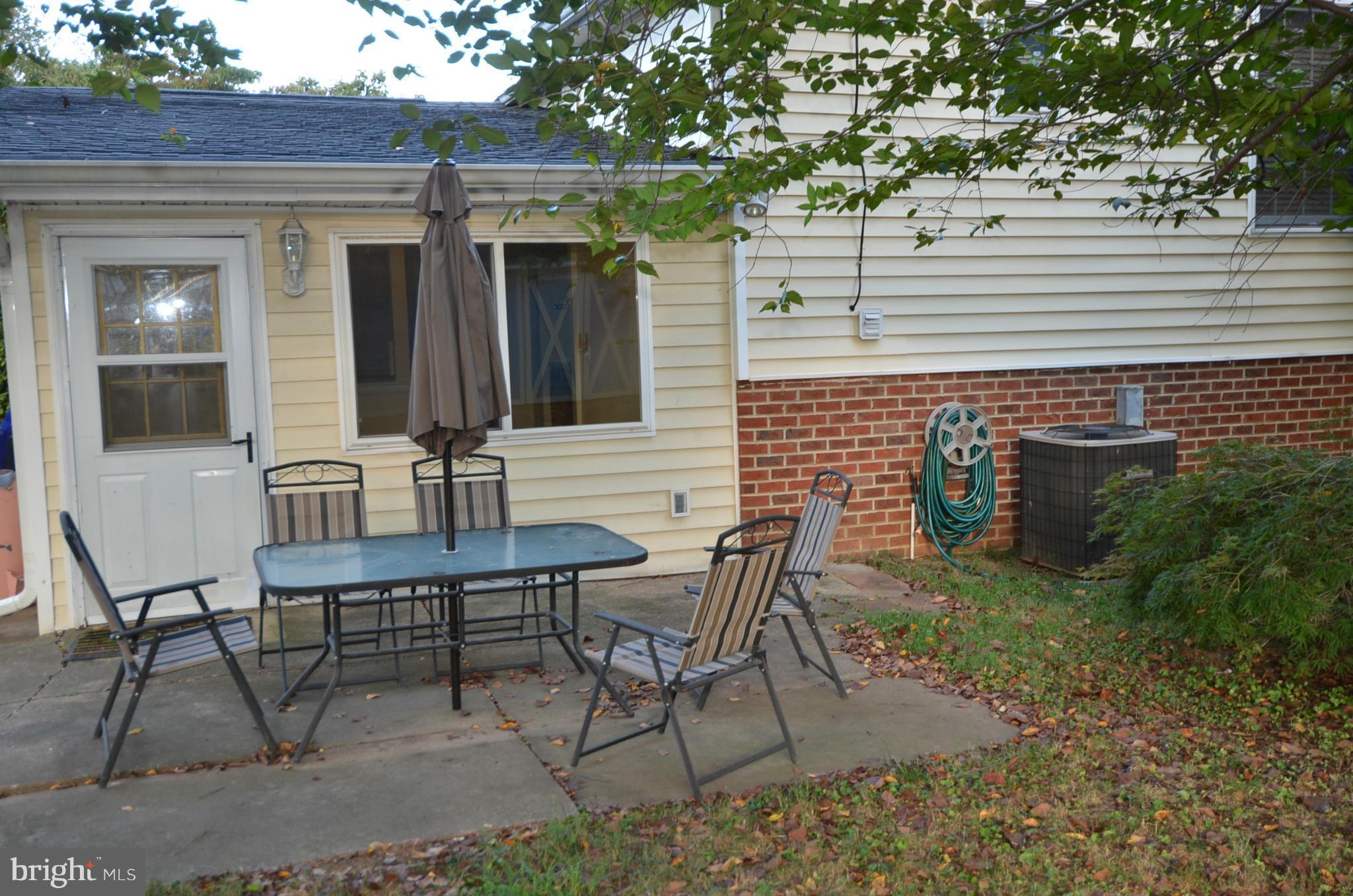 11806 Selfridge Road Silver Spring, MD 20906 - Photo 23 of 25 a view of a patio with table and chairs and potted plants