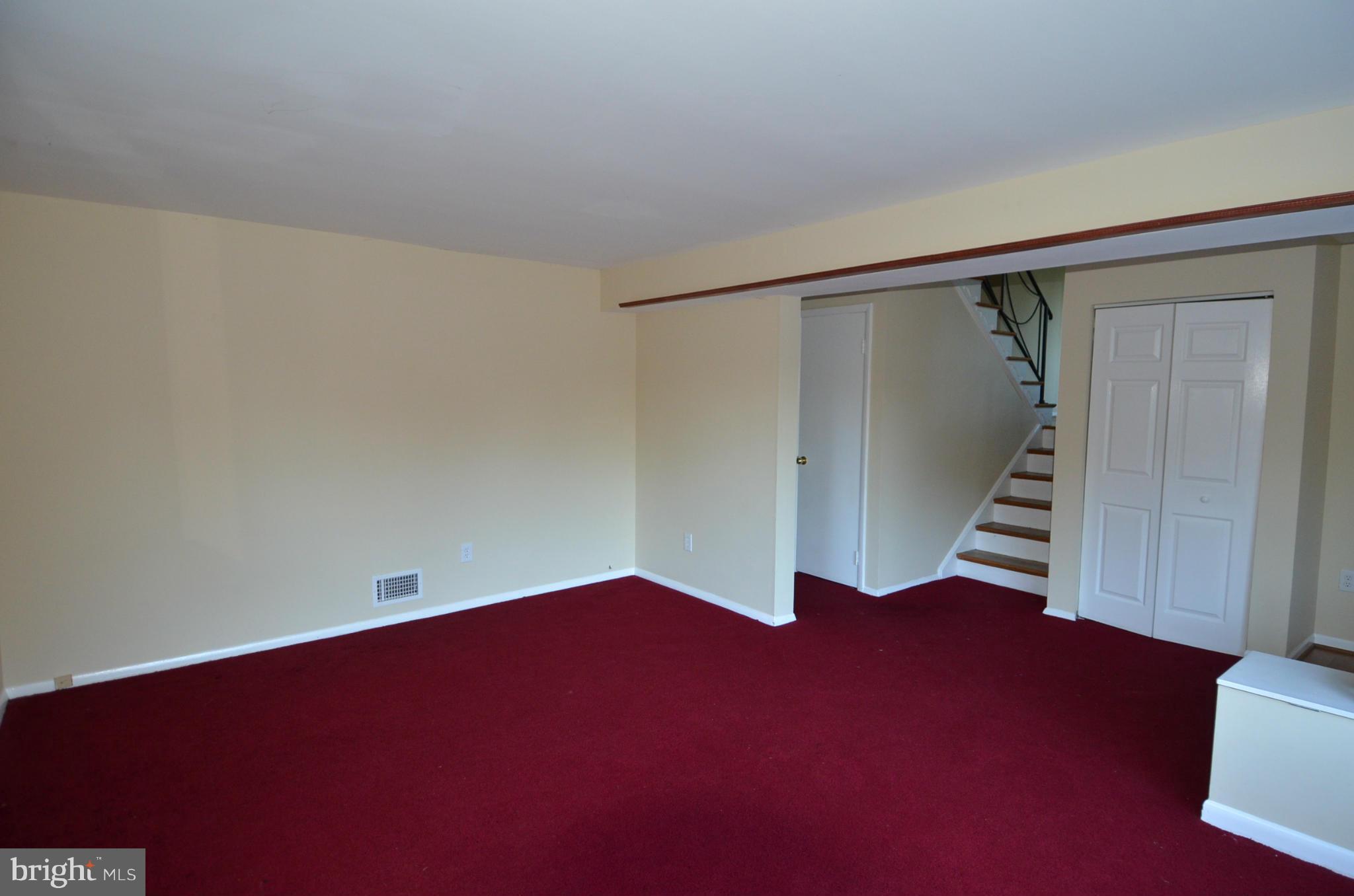 11806 Selfridge Road Silver Spring, MD 20906 - Photo 4 of 25 a view of an empty room with wooden floor and stairs
