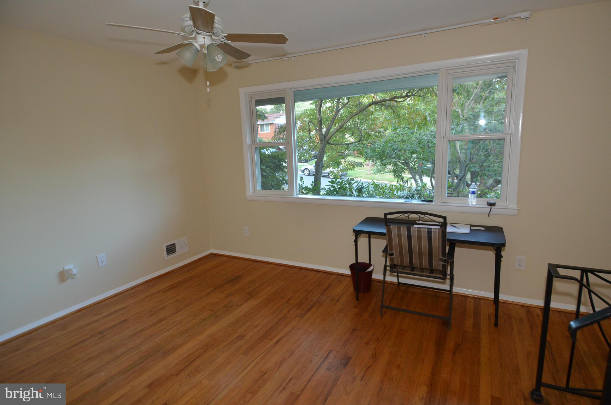 11806 Selfridge Road Silver Spring, MD 20906 - Photo 5 of 25 a view of room with hardwood floor and a ceiling fan