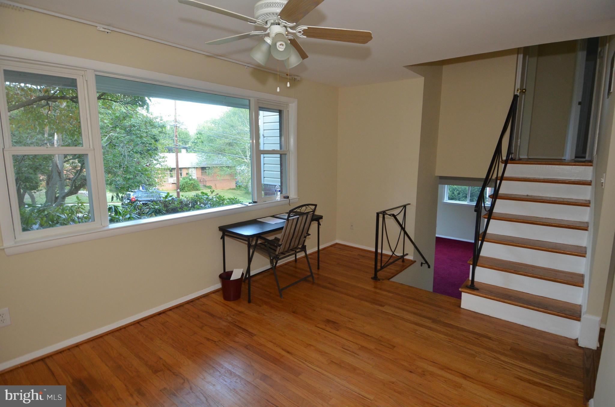 11806 Selfridge Road Silver Spring, MD 20906 - Photo 6 of 25 a view of a room with wooden floor fan and windows