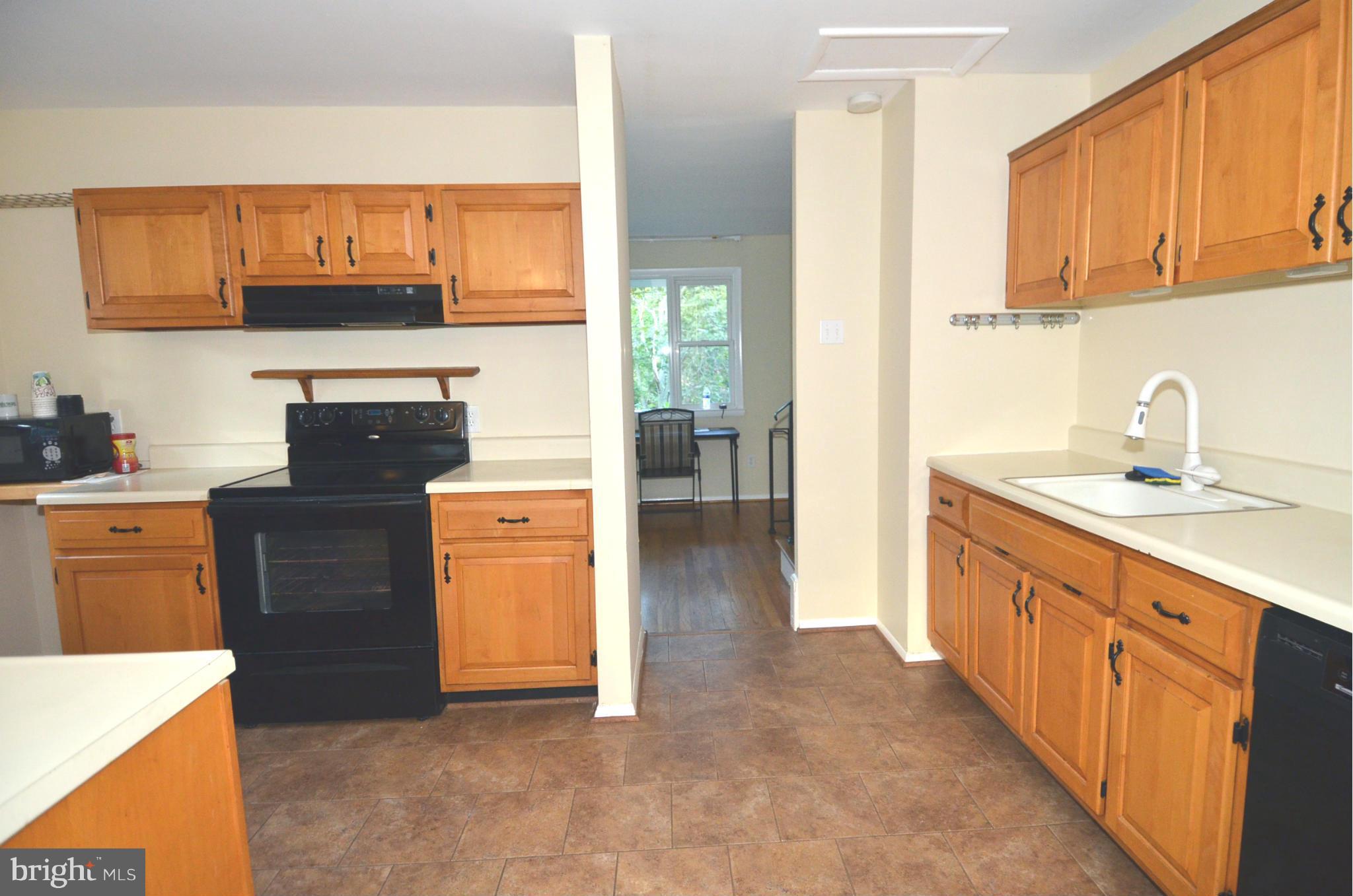 11806 Selfridge Road Silver Spring, MD 20906 - Photo 7 of 25 a kitchen with stainless steel appliances granite countertop a stove and a refrigerator