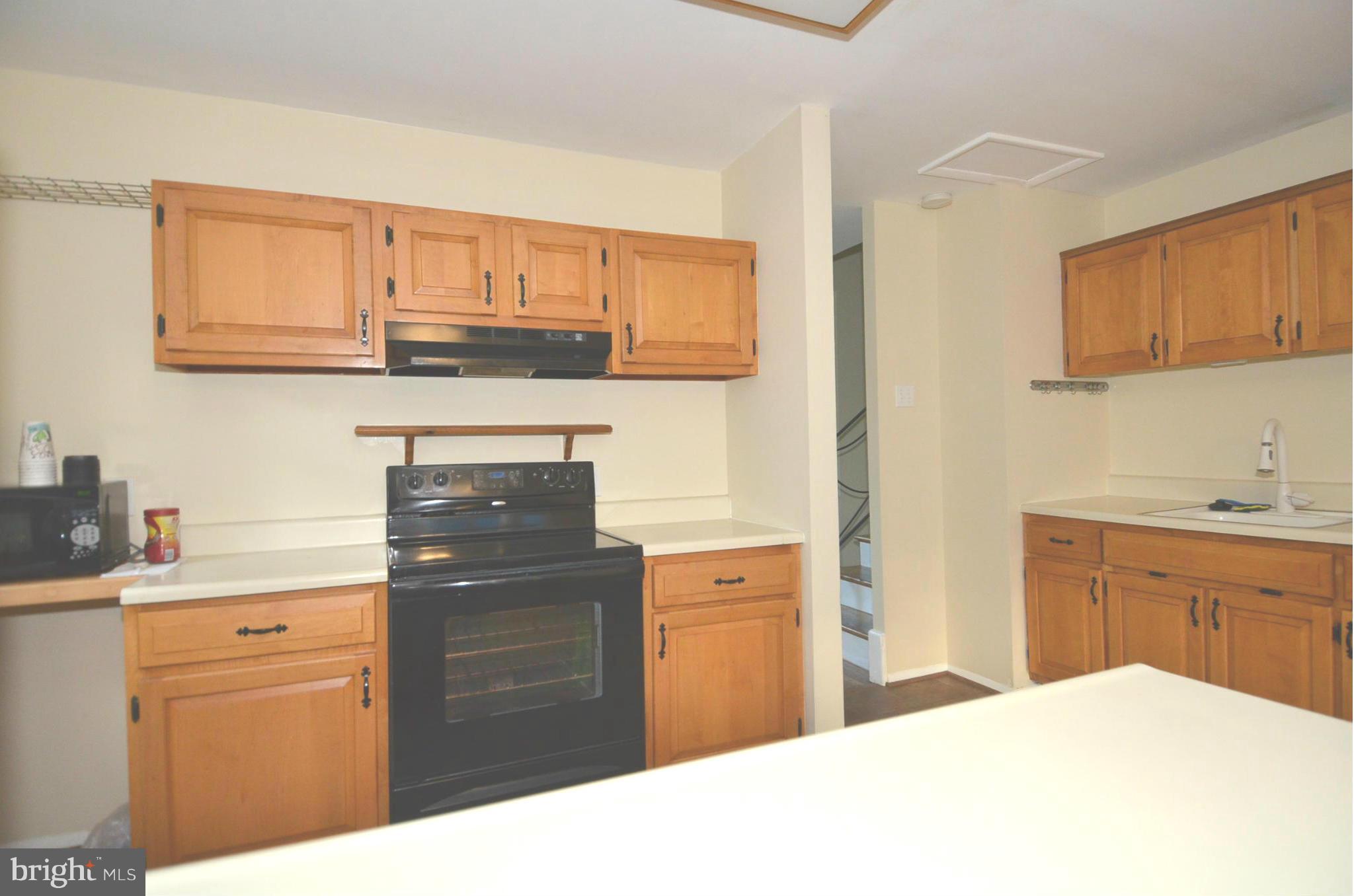 11806 Selfridge Road Silver Spring, MD 20906 - Photo 8 of 25 a kitchen with a sink dishwasher and cabinets