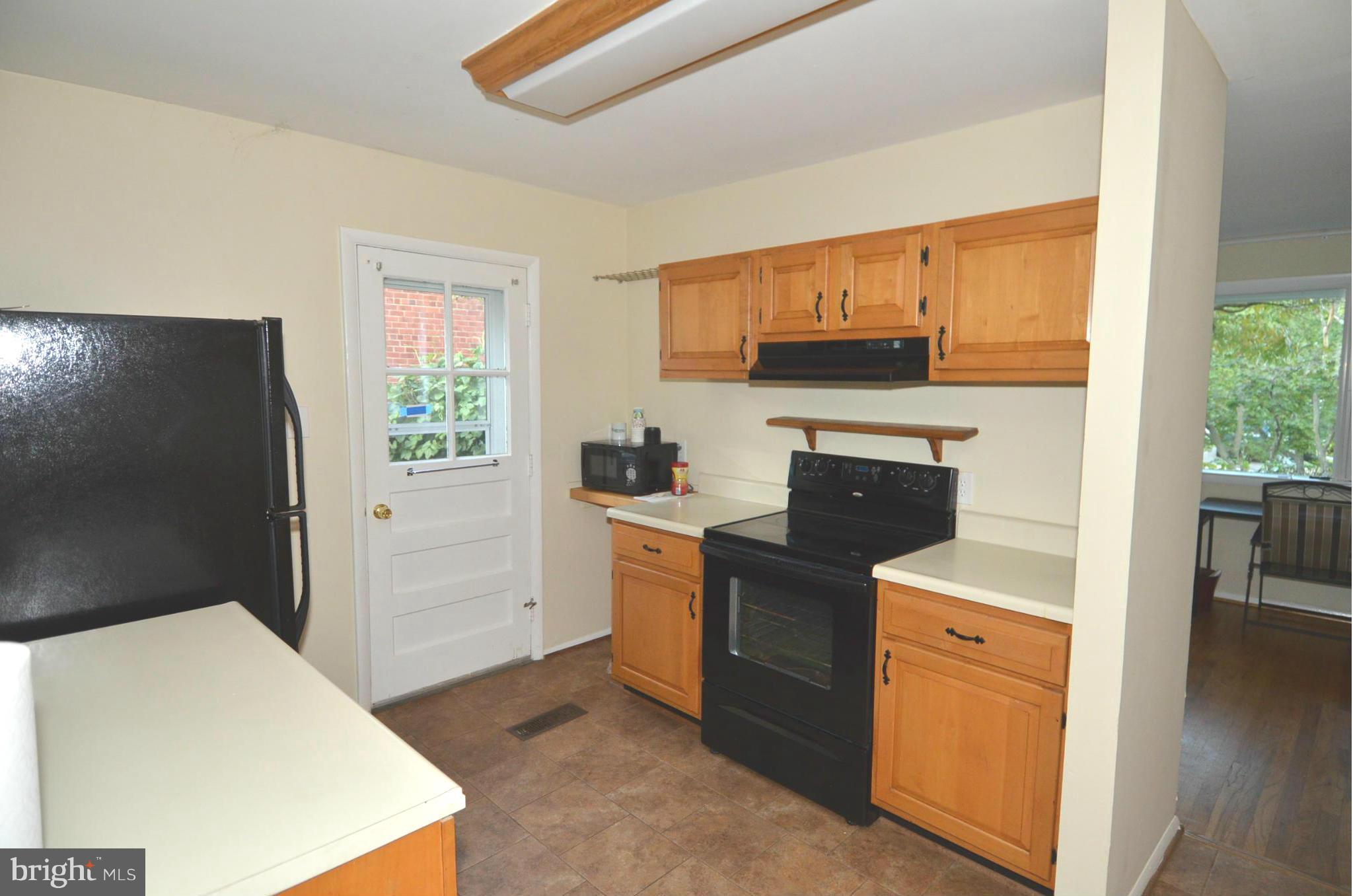 11806 Selfridge Road Silver Spring, MD 20906 - Photo 9 of 25 a kitchen with a stove a sink and a refrigerator