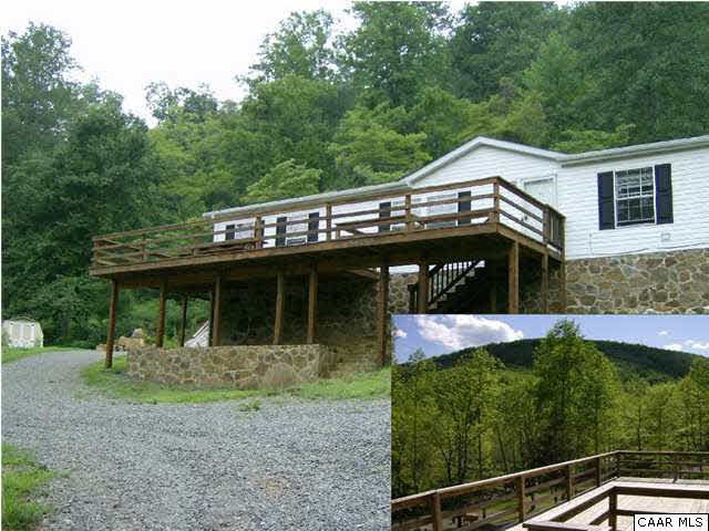 1733 Mutton Hollow Road Stanardsville, VA 22973 - Photo 1 of 12 a front view of a house with garden