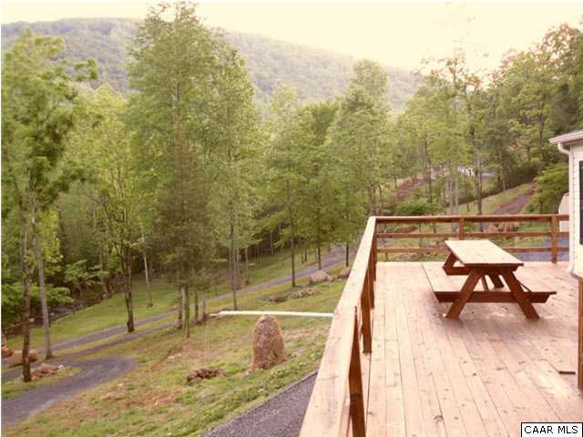 1733 Mutton Hollow Road Stanardsville, VA 22973 - Photo 8 of 12 a view of a swimming pool with a bench