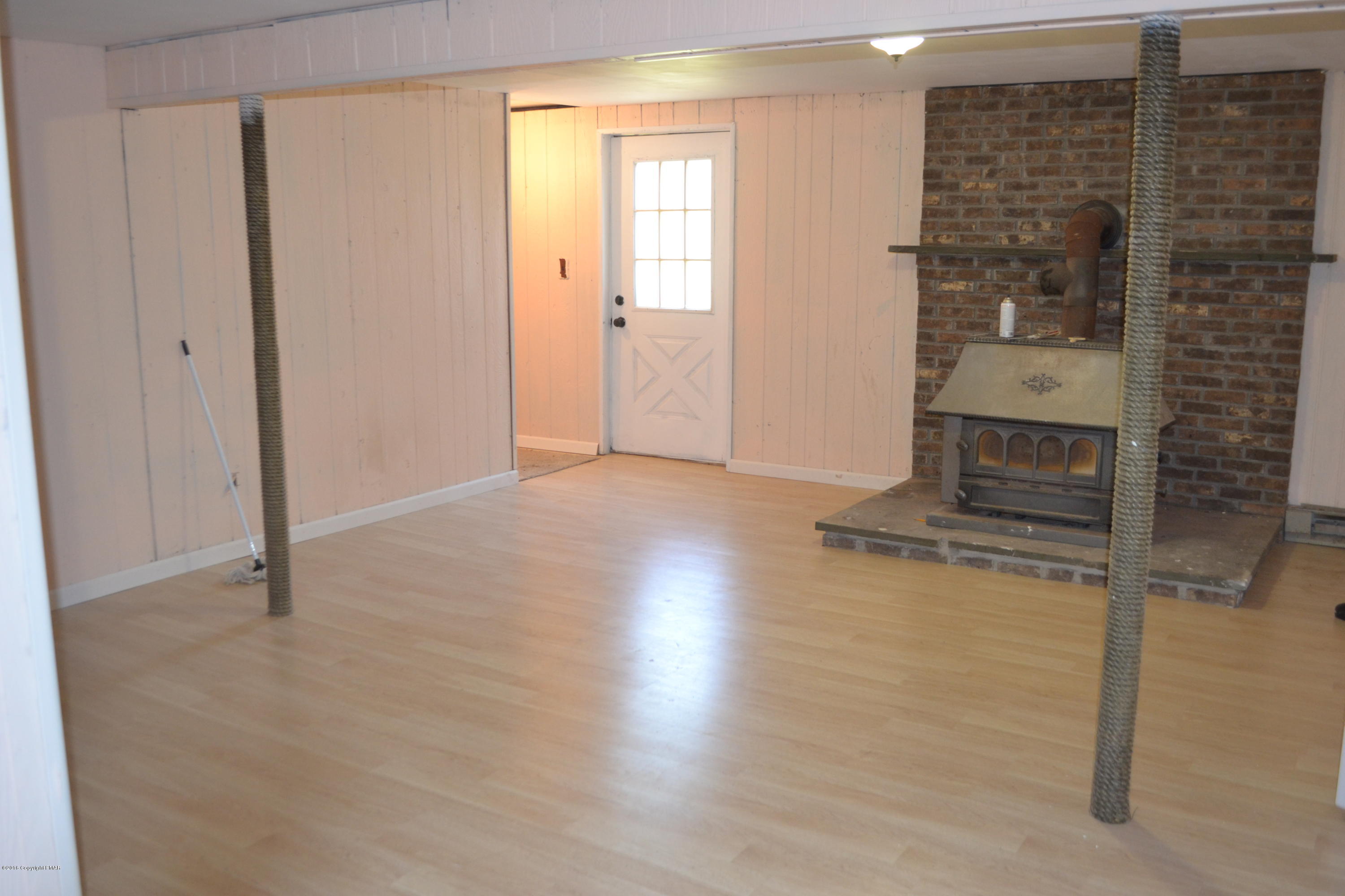 1015 Clover Road Long Pond, PA 18334 - Photo 25 of 35 an empty room with wooden floor cabinet and windows