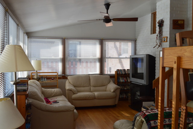 2063 Downey Road Homewood, IL 60430 - Photo 4 of 8 a living room with furniture a flat screen tv and a window