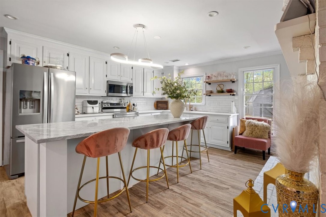 9820 Beaver Bridge Road Chesterfield, VA 23838 - Photo 16 of 51 The kitchen features white cabinetry, stainless st