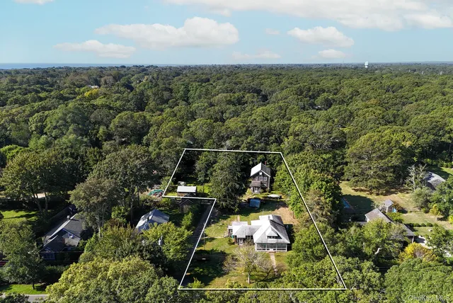 an aerial view of houses with yard