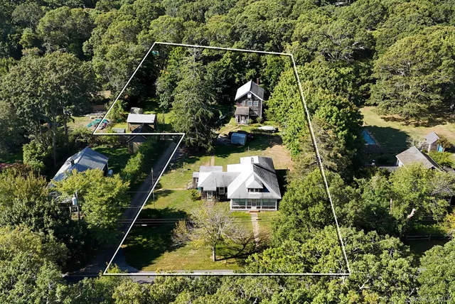 an aerial view of a house with a yard