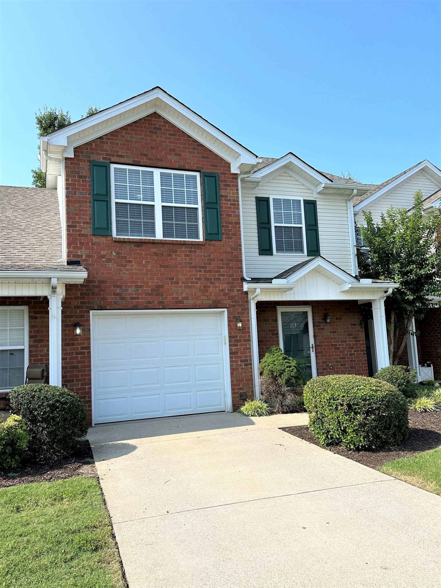 113 Lancaster Gate Place Murfreesboro, TN 37128 - Photo 2 of 28 a front view of a house with a yard and garage