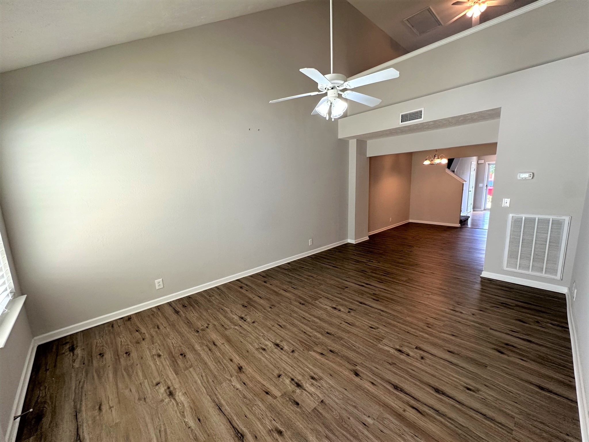 113 Lancaster Gate Place Murfreesboro, TN 37128 - Photo 5 of 28 a view of an empty room with wooden floor and a window