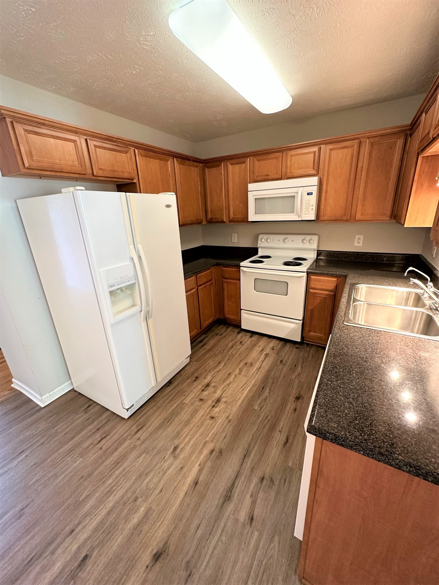 113 Lancaster Gate Place Murfreesboro, TN 37128 - Photo 8 of 28 a kitchen with a refrigerator a stove top oven a sink and dishwasher with wooden floor